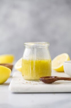 Homemade lemon vinaigrette in a glass jar.