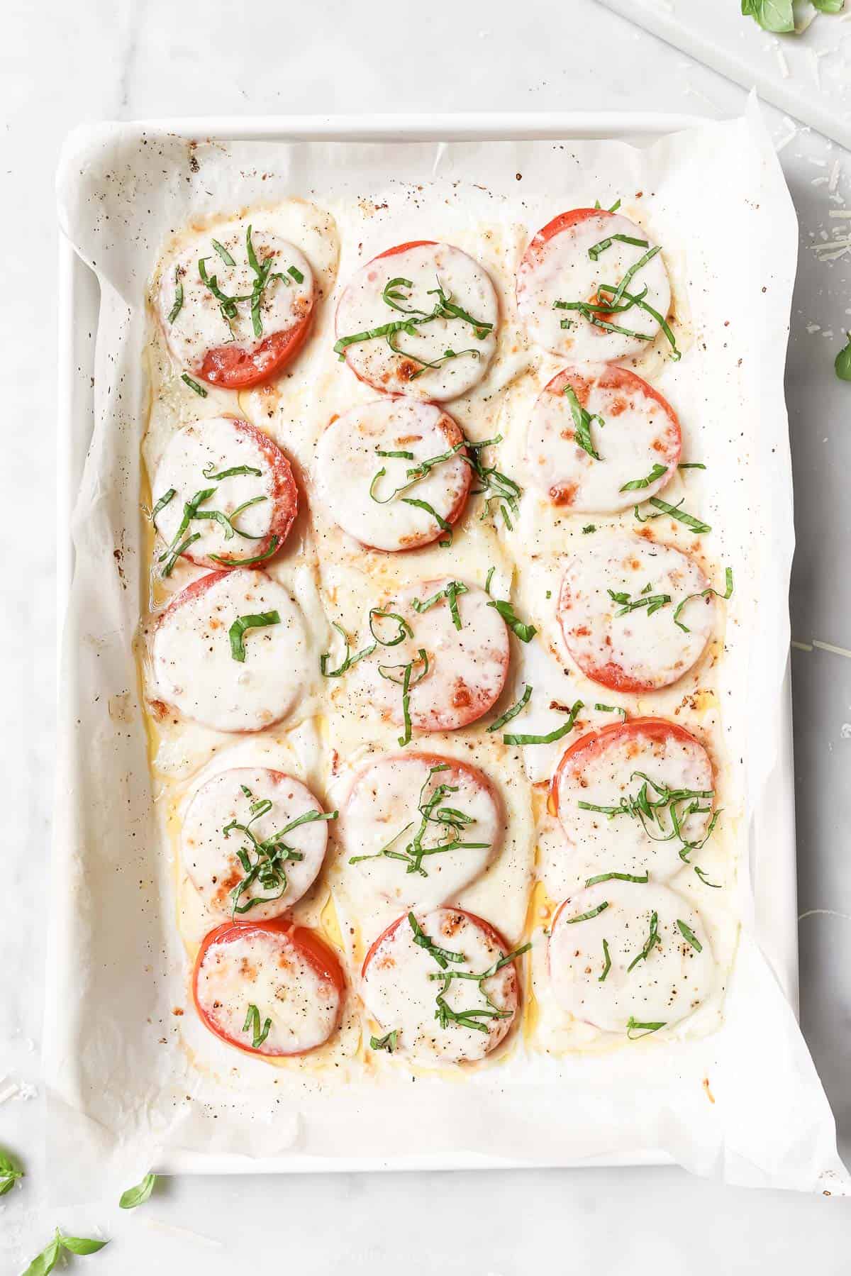 Baked tomato on lined baking sheet. 