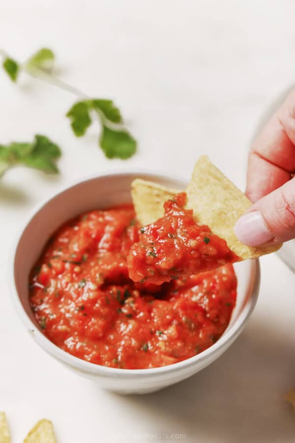 Dipping a chip into the ،memade salsa.