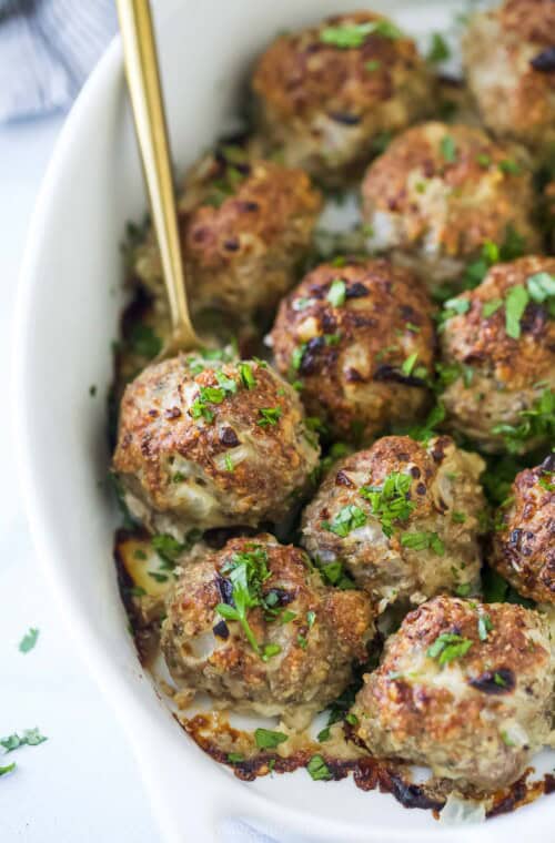 Close-up of the baked meatballs with fresh parsley on top.