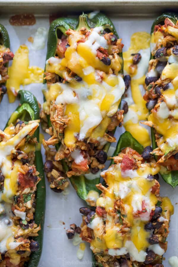 Close-up of baked poblanos with melted Mexican cheese.