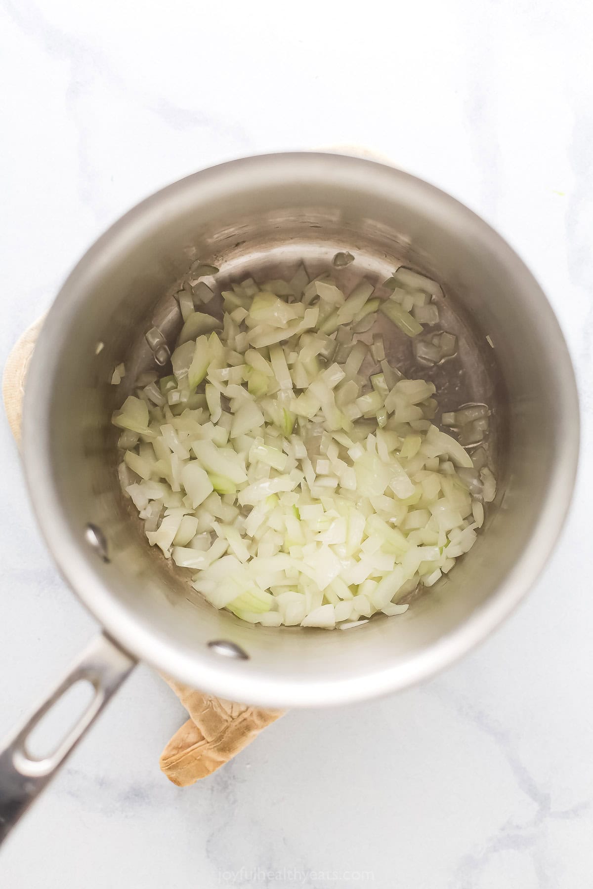 Cooking the onions in the pot. 