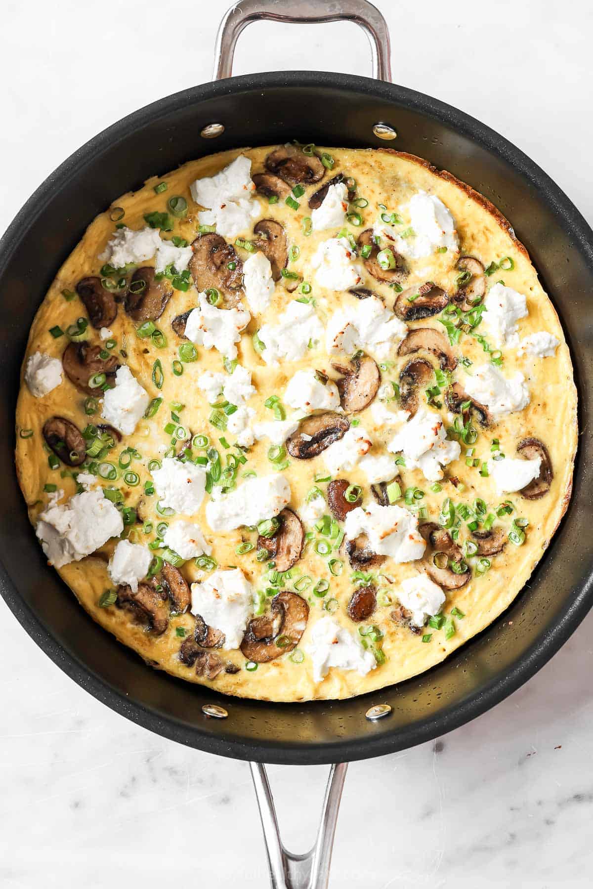 Adding green onions and goat cheese on top before baking. 