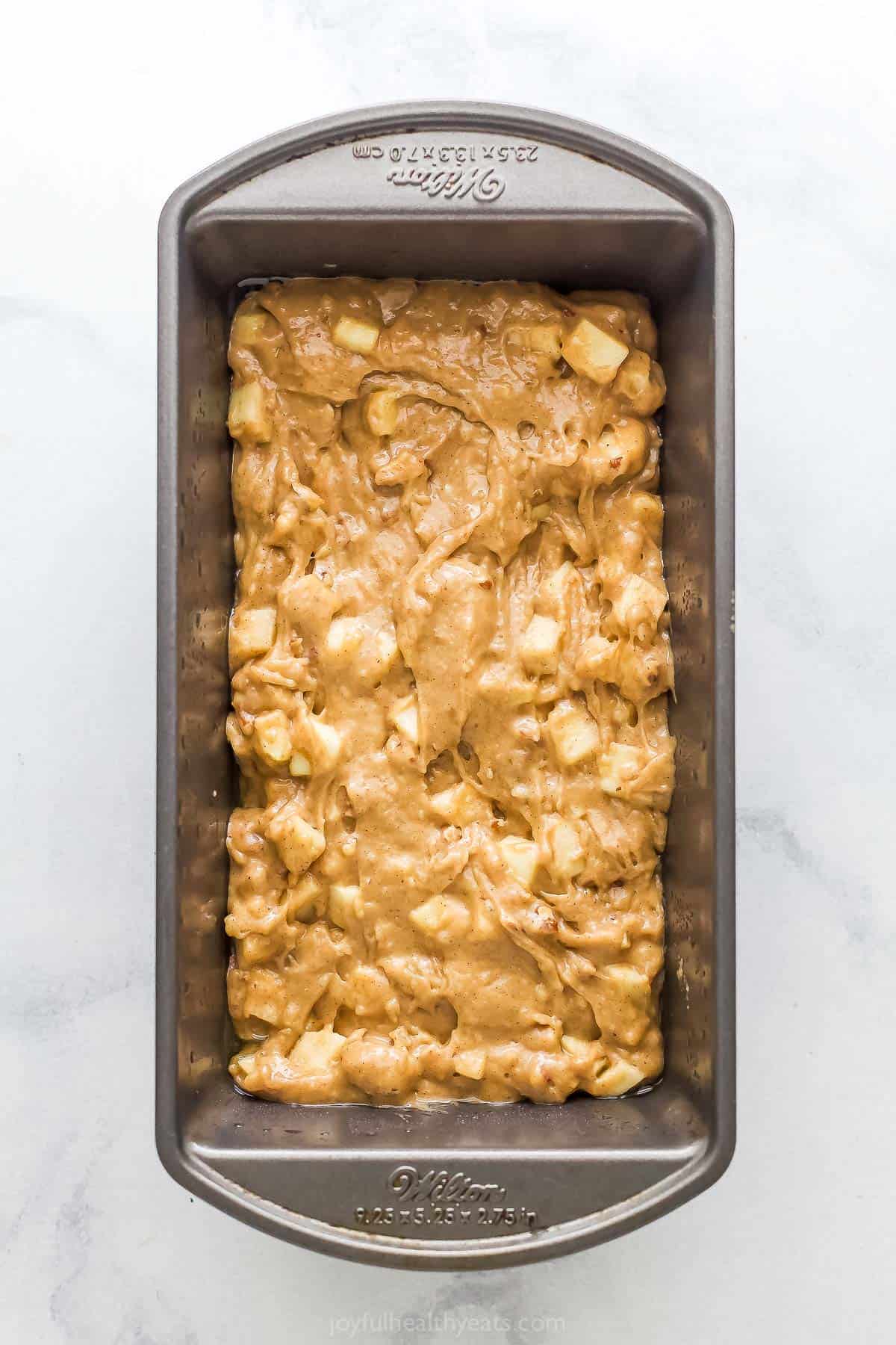 Pouring the batter into the greased loaf pan. 