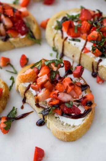Strawberry bruschetta with a drizzle of tangy balsamic reduction on top.