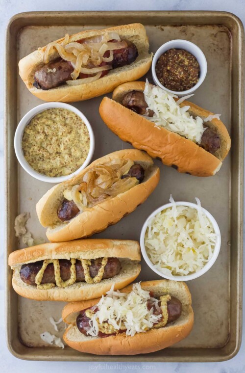 Tray of hot dogs with different toppings.