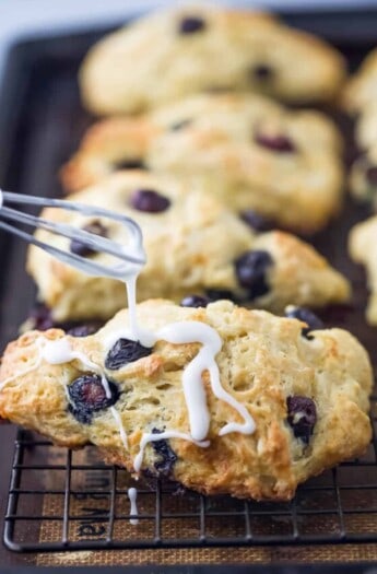 Drizzling the glaze over the scones.