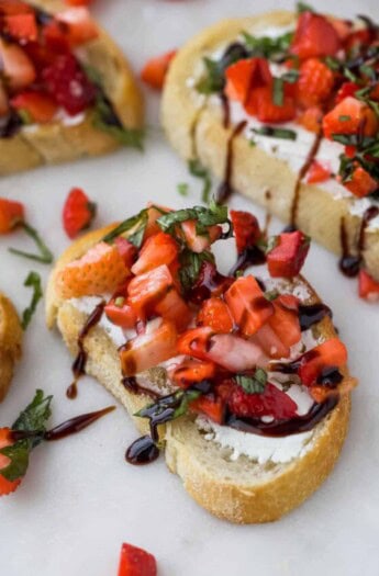 Strawberry bruschetta with a drizzle of tangy balsamic reduction on top.