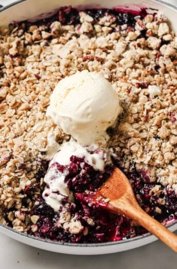 Blueberry cobbler with a scoop of vanilla ice cream.