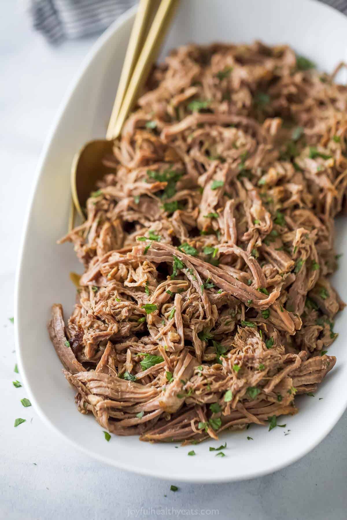 Shredded beef on a serving plate from the Shredded Beef Sandwich recipe. 