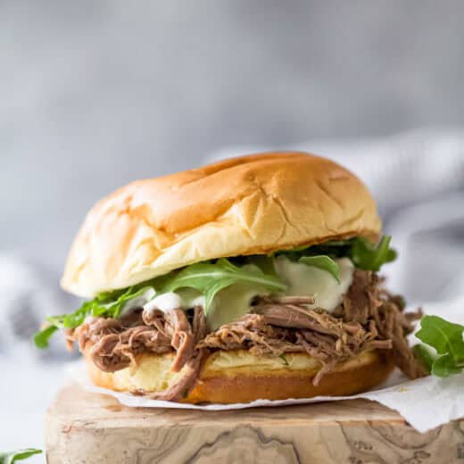 Homemade shredded beef sandwich with arugula, horseradish aioli, and melty provolone cheese.