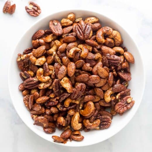 A bowl of homemade maple syrup spiced candied nuts.