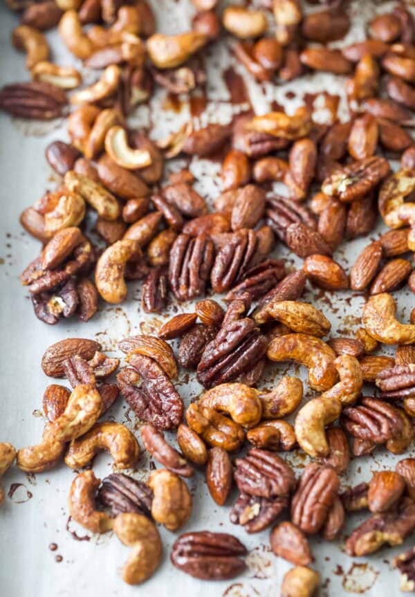 Toasty candied nuts on a baking sheet lined with parchment paper.