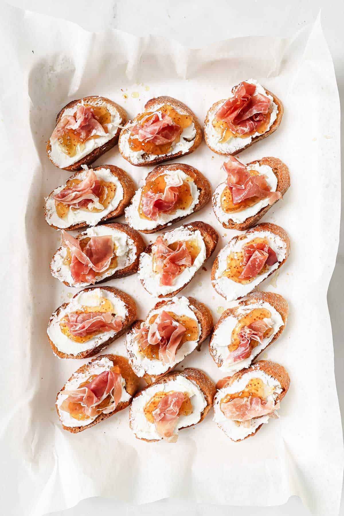 Toasty crostinis with goat cheese, fig jam and prosciutto.