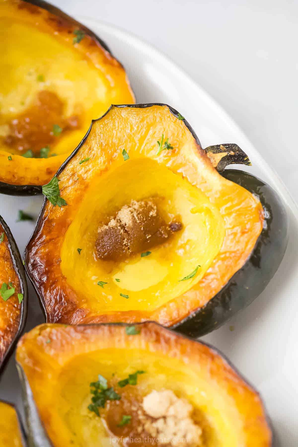 Close-up of a tender acorn squash with brown sugar and melted butter.