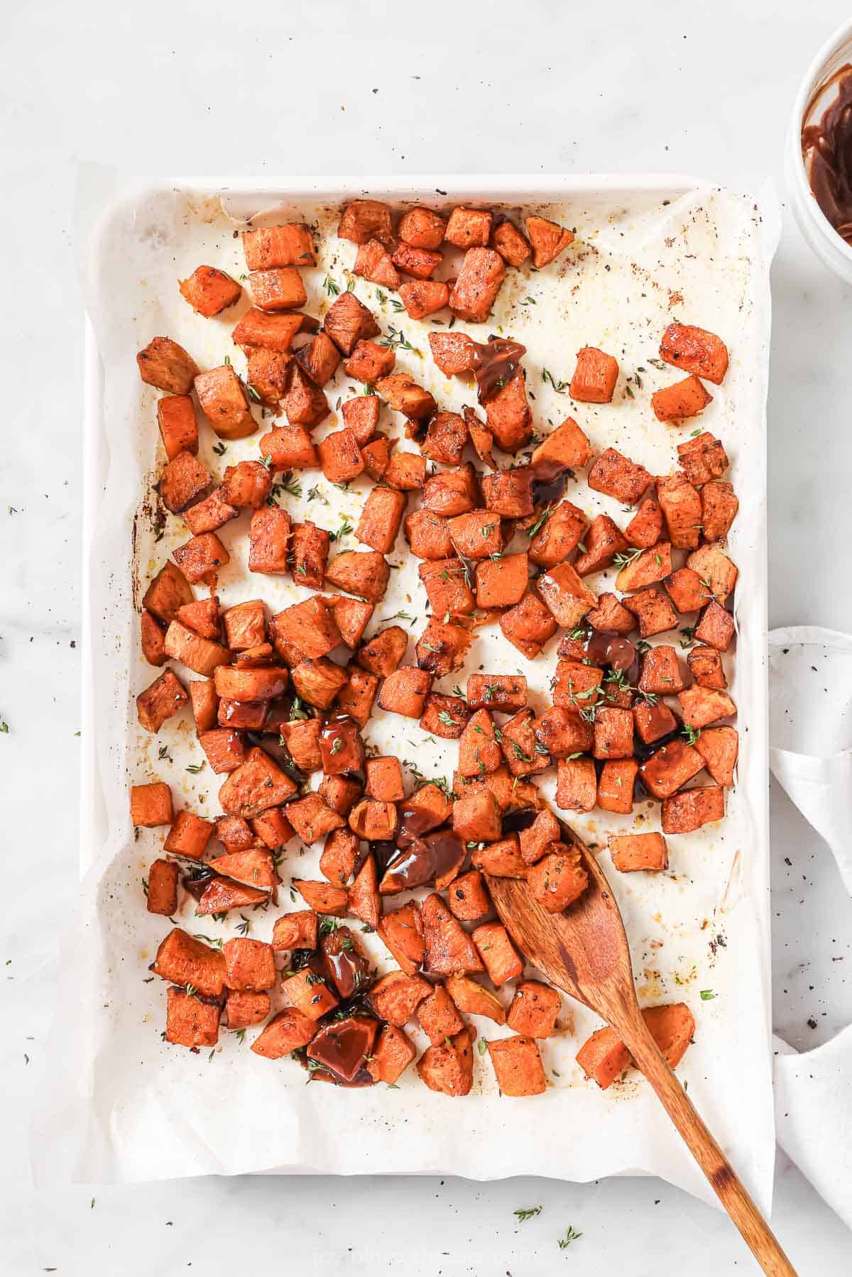 Freshly roasted sweet potato hash on baking sheet. 