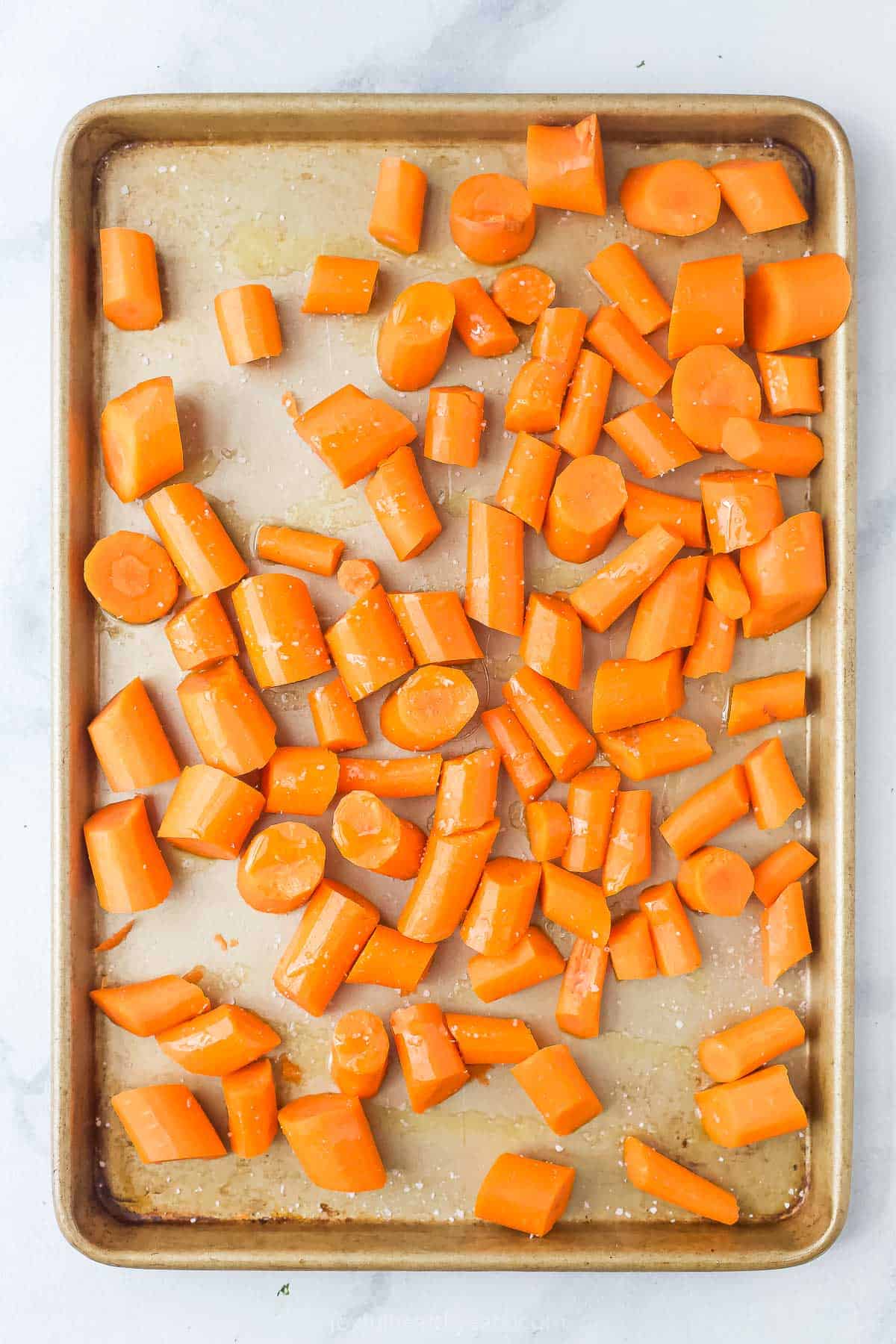 Chopped carrots on the baking sheet. 