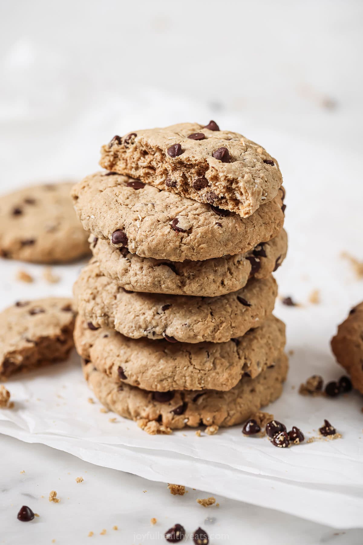 A stack of freshly-baked coconut chocolate chip oatmeal cookies. 