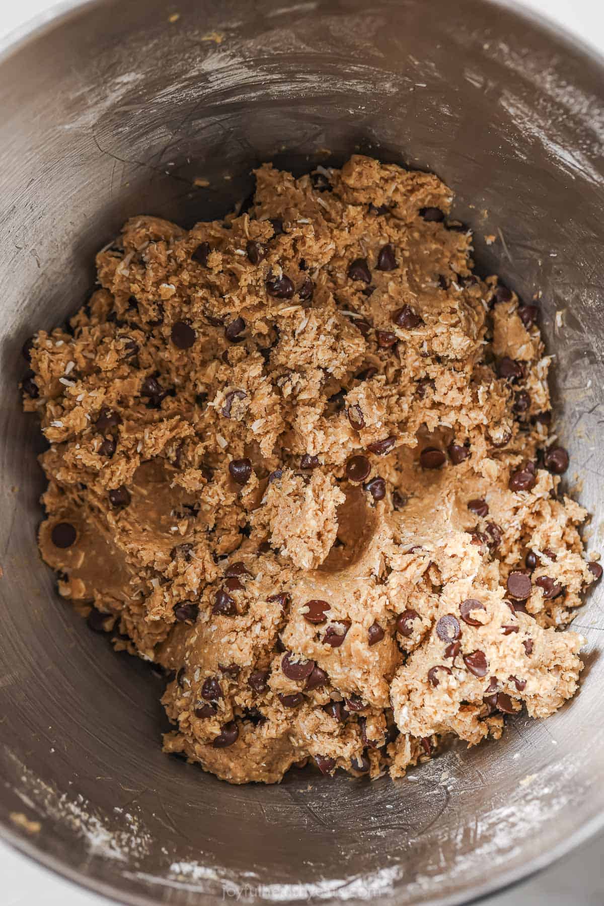 Cookie dough with chocolate chips and folded in shredded coconut. 