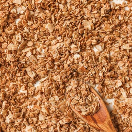 Overhead view of granola on pan with spoon