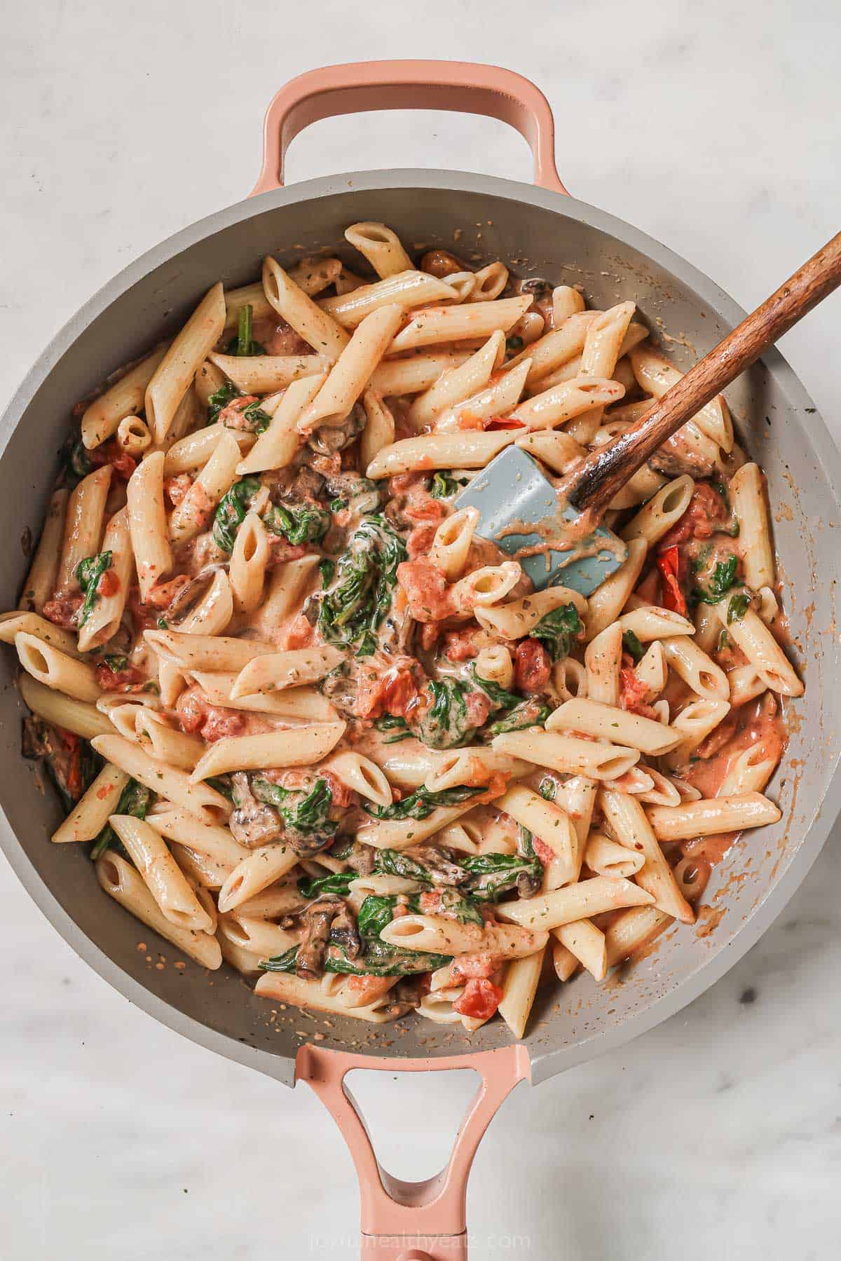 Creamy Italian pasta with veggies in the skillet. 