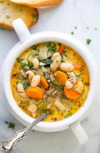 a bowl of soup filled with epic creamy tuscan white bean soup