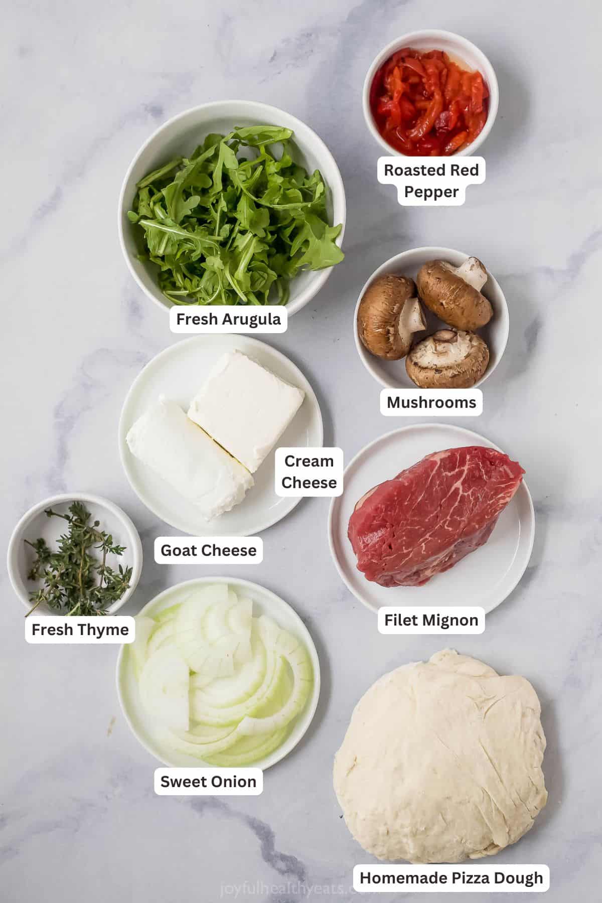 Overhead view of ingredients for homemade steak pizza with labels