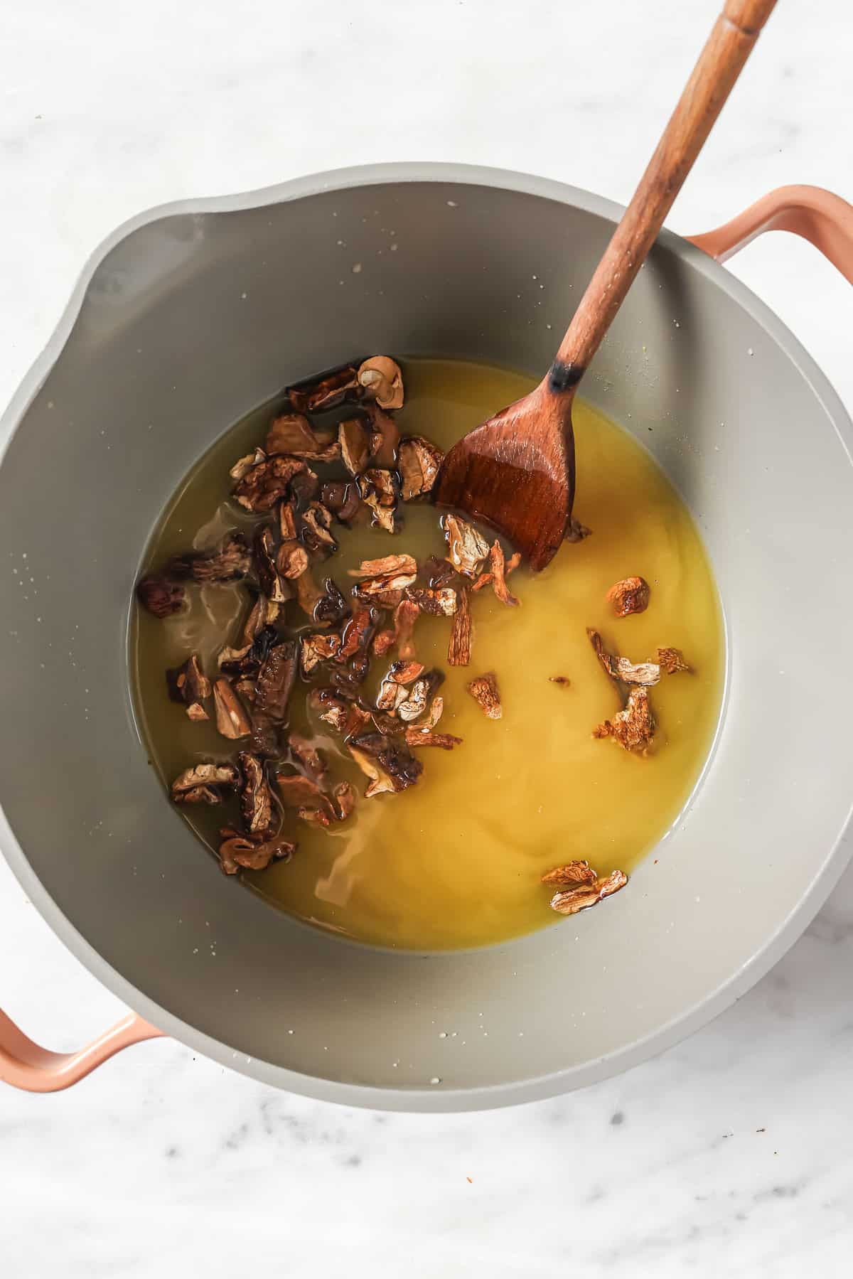 Simmering the mushrooms in the pot. 