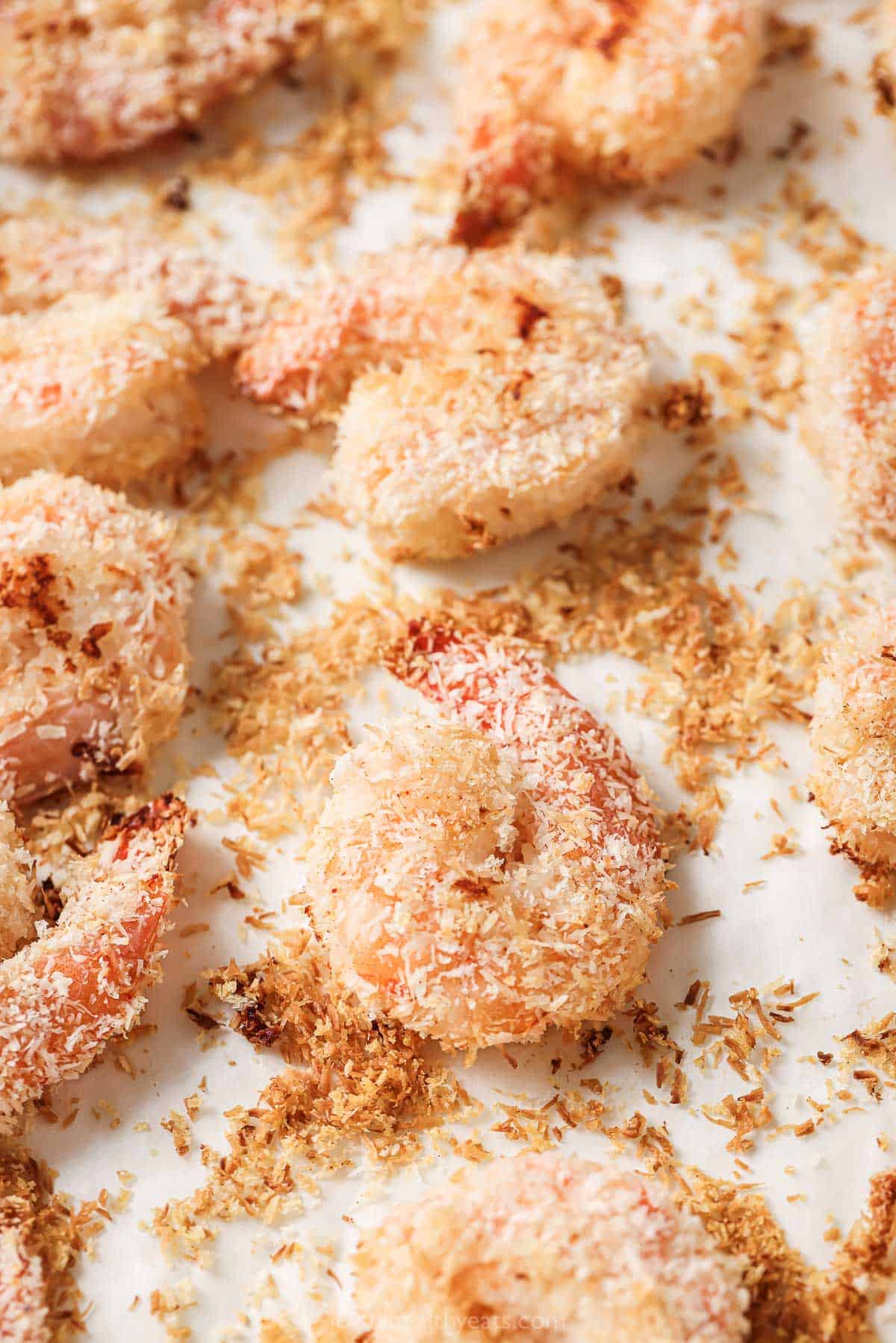 Close-up of crispy coconut-breaded baked shrimp. 