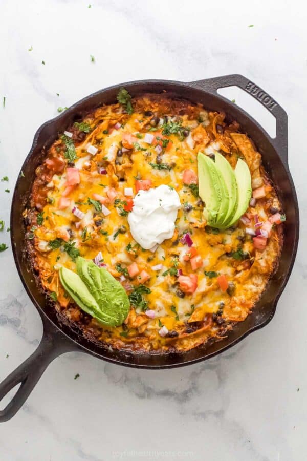 Cheesy Chicken Enchilada Casserole with Sour Cream, Avocado and Pico de Gallo.