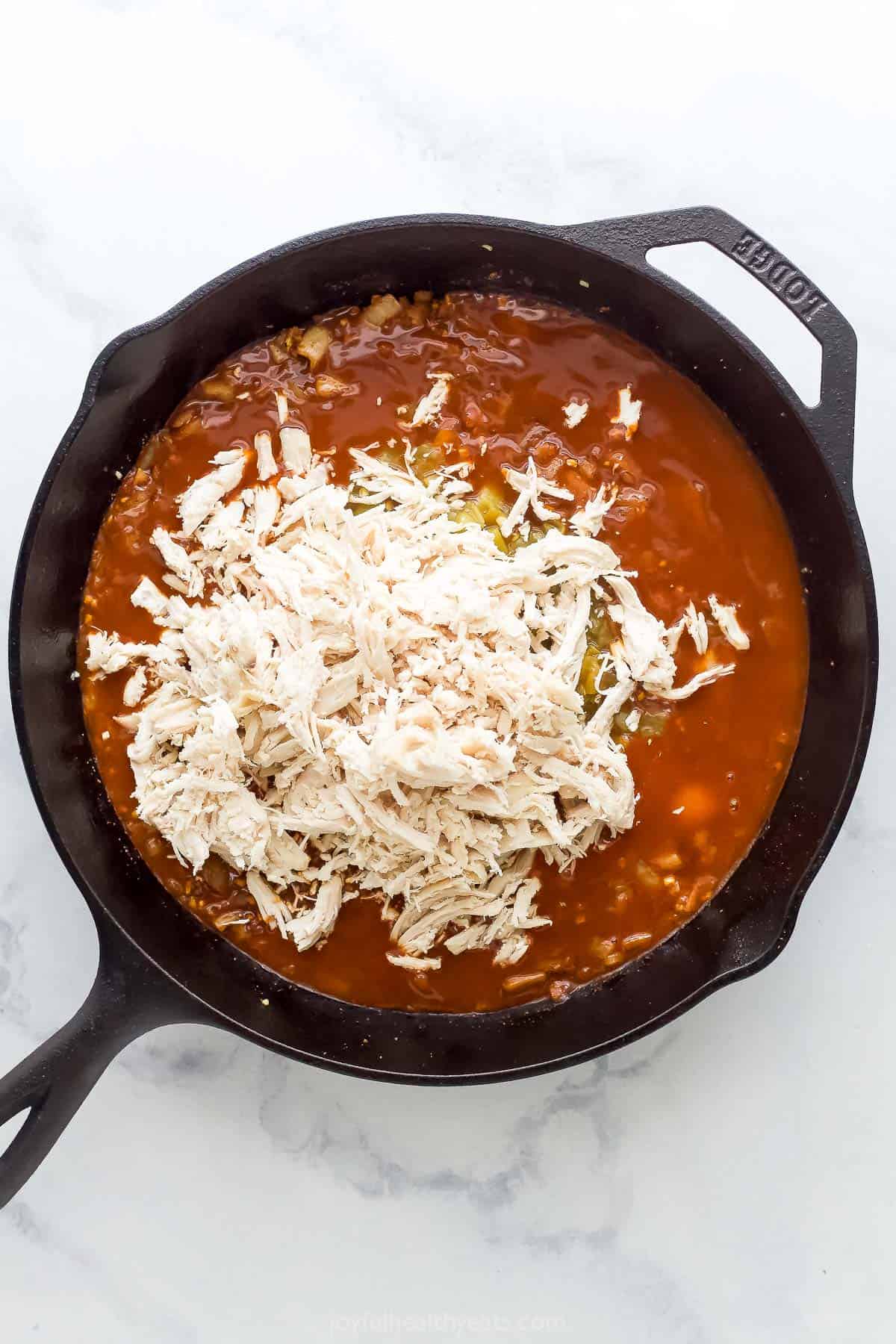 Adding the chicken into the sauce mixture in the skillet. 