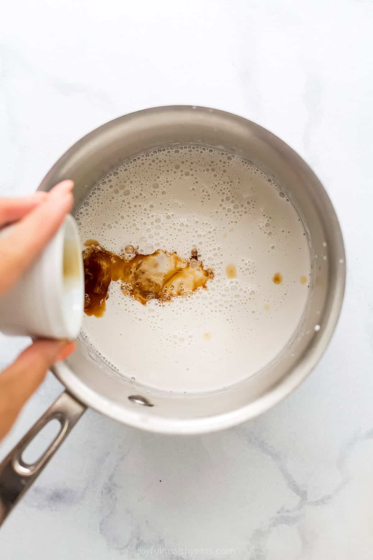 Adding the vanilla extract to the mixture.