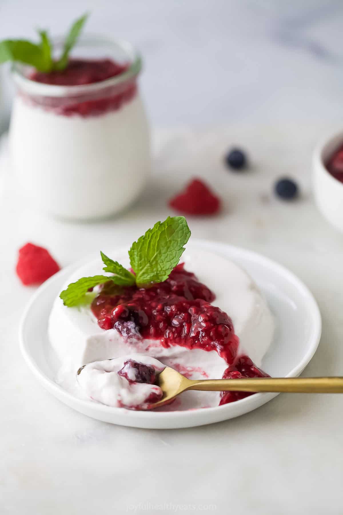 Creamy panna cotta with homemade berry compote on a plate.