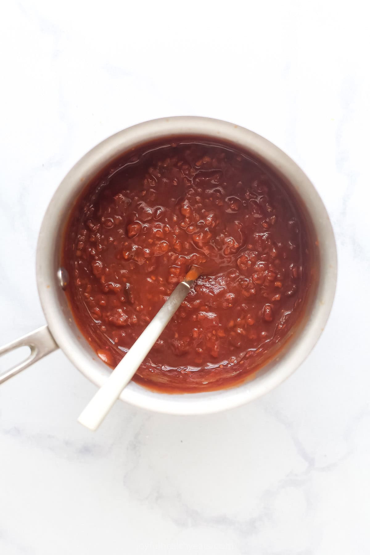 Cooling the sauce in the pot once ready.