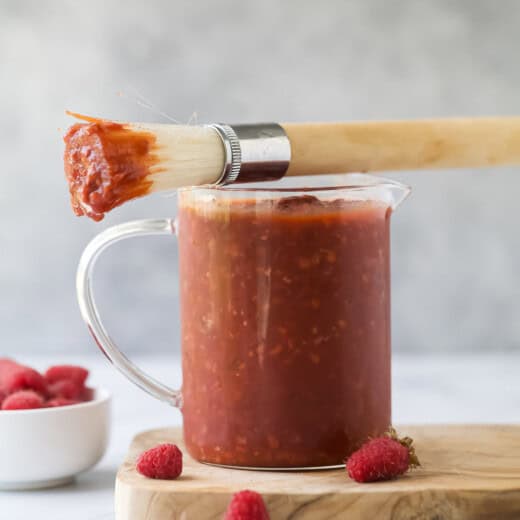 Raspberry chipotle BBQ sauce in a small glass pitcher.
