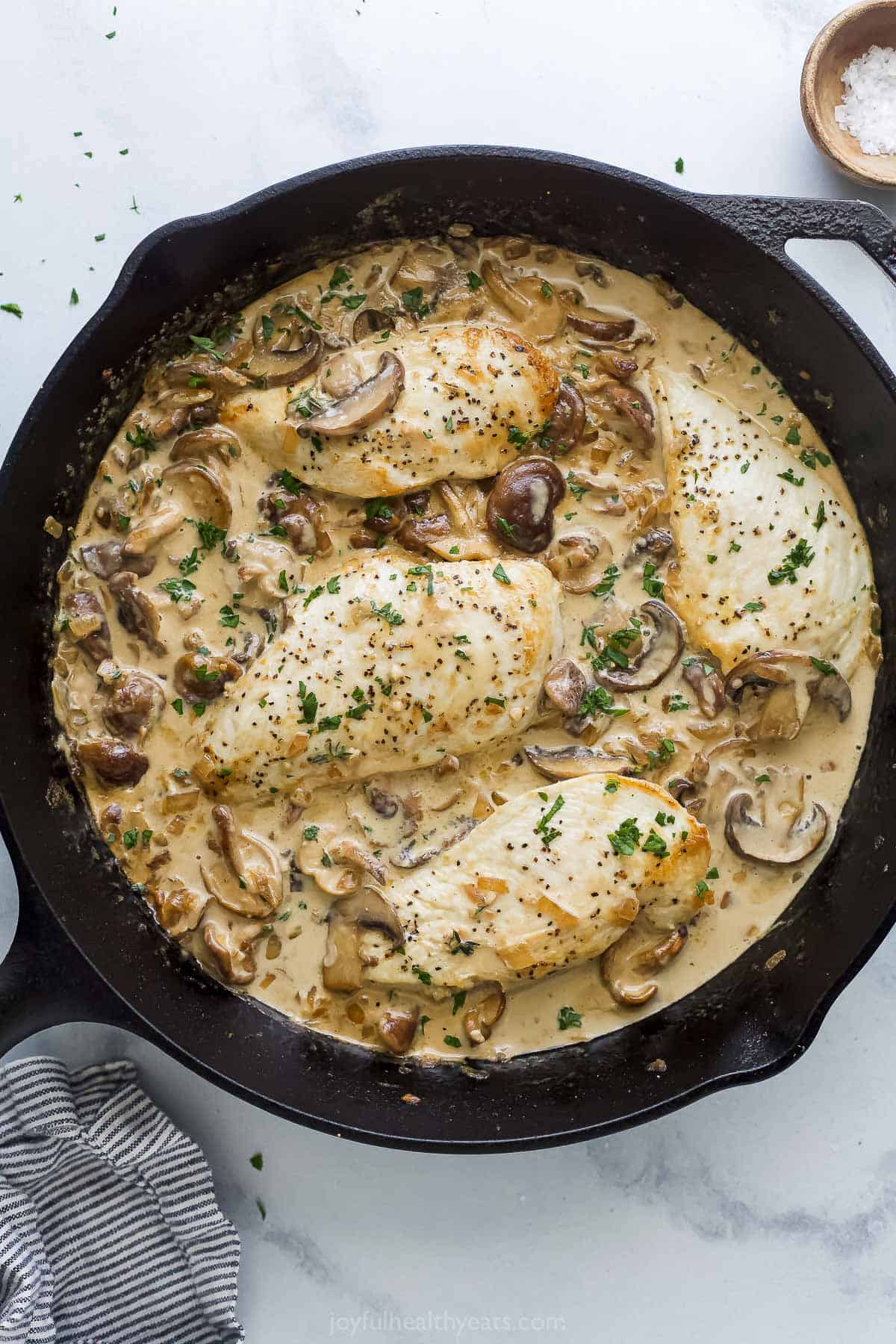 Dairy-free pan-seared chicken with mushroom sauce in the skillet. 