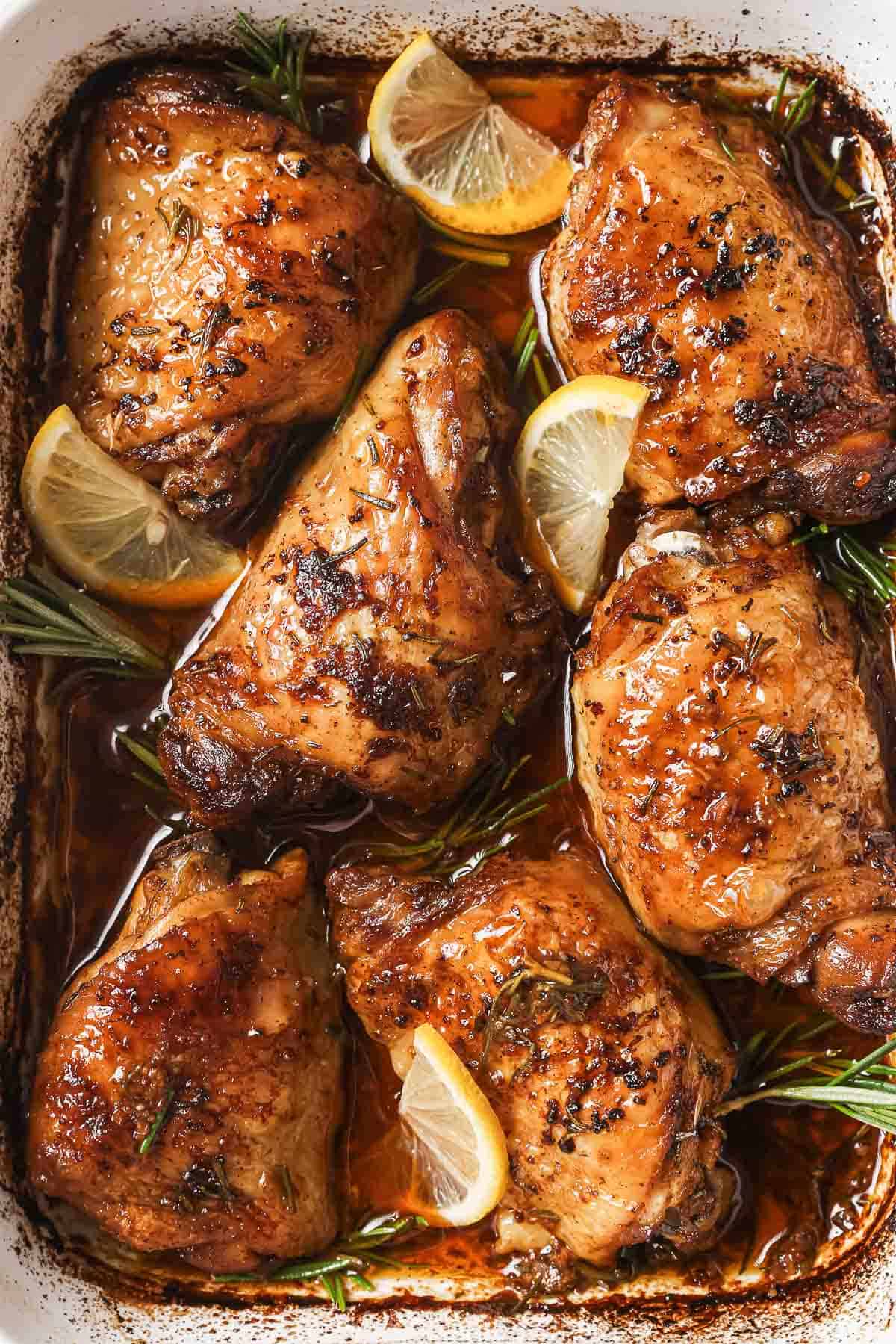 Close-up of the herby lemon chicken thighs in the baking dish. 