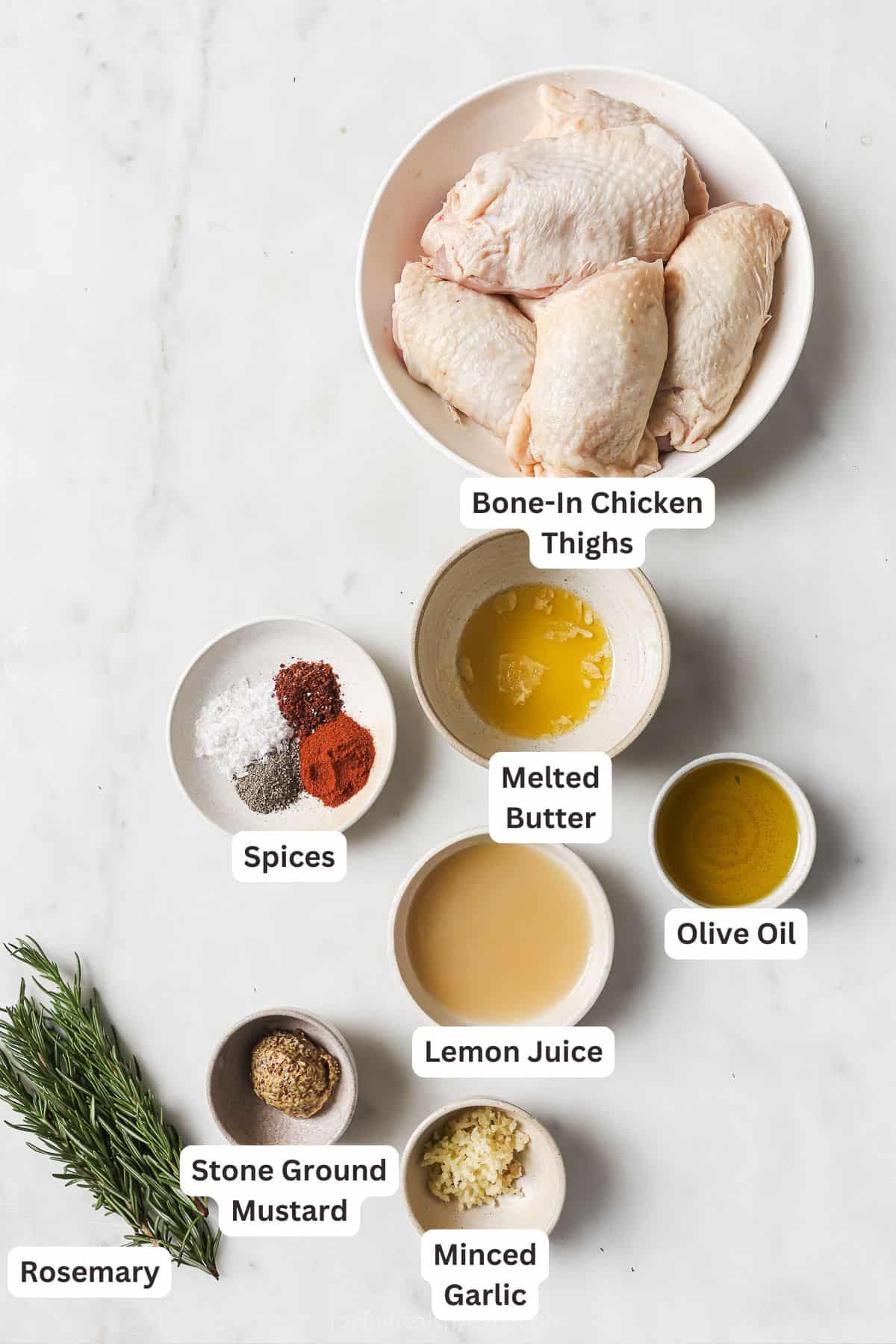 Labeled ingredients for making lemon rosemary chicken. 