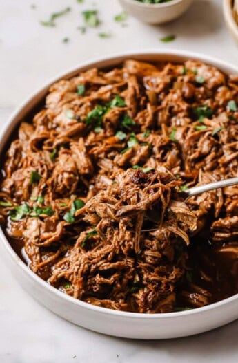 Grabbing some saucy pulled pork with a fork.