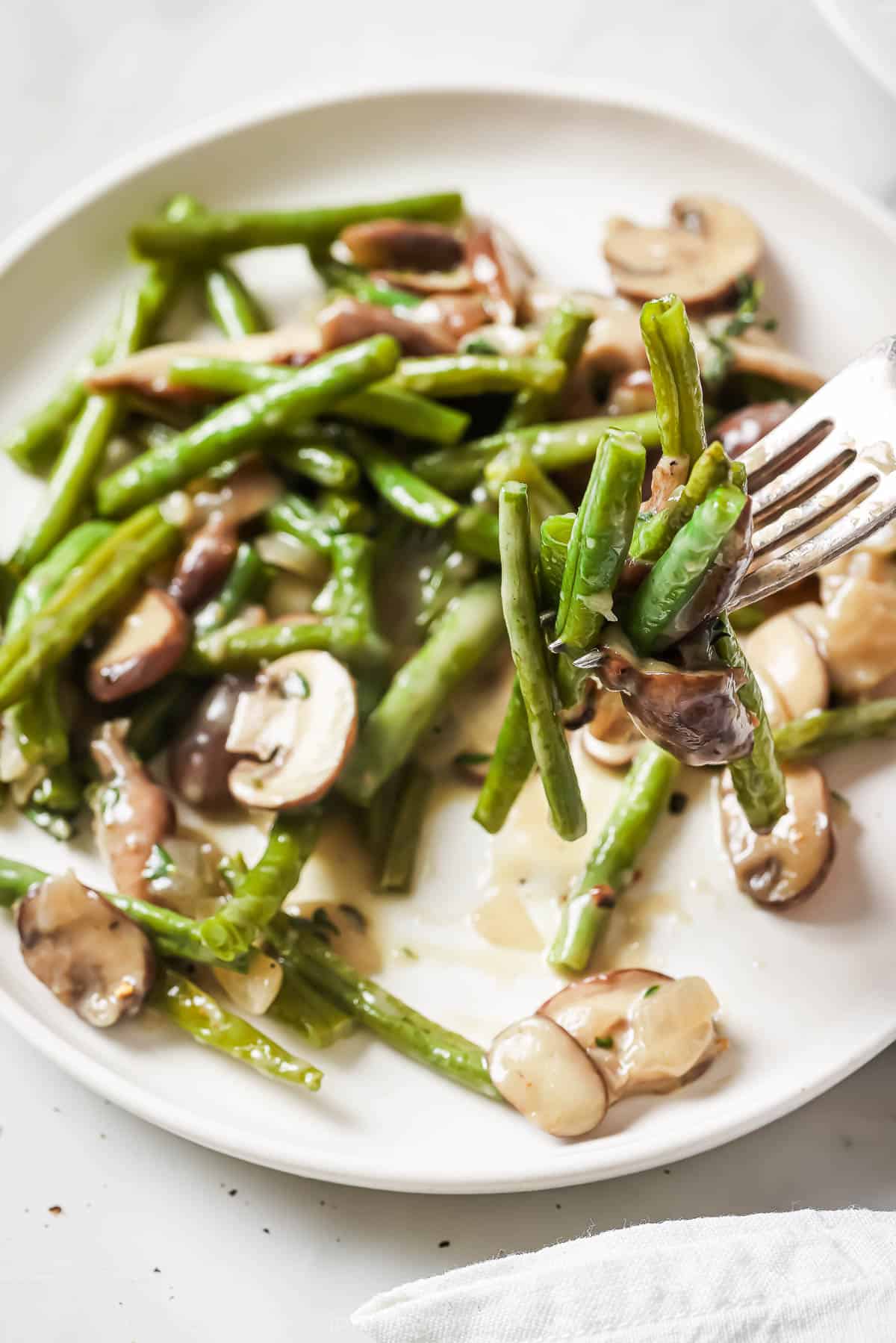 Roasted greens with creamy sautéed mushroom sauce on top.