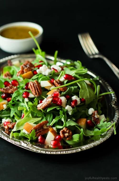 Pomegranate Goat Cheese Candied Pecan Arugula Salad. The perfect salad to change up your holiday menu, easy to make and absolutely delicious! | www.joyfulhealthyeats.com