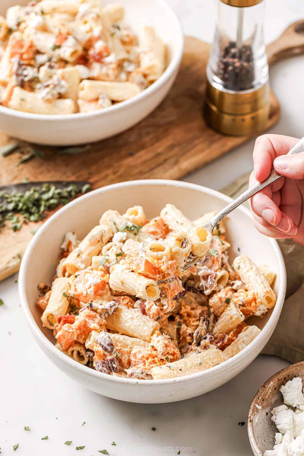 Digging into a bowl of comforting, fall-flavored rigatoni with a melted goat cheese sauce. 