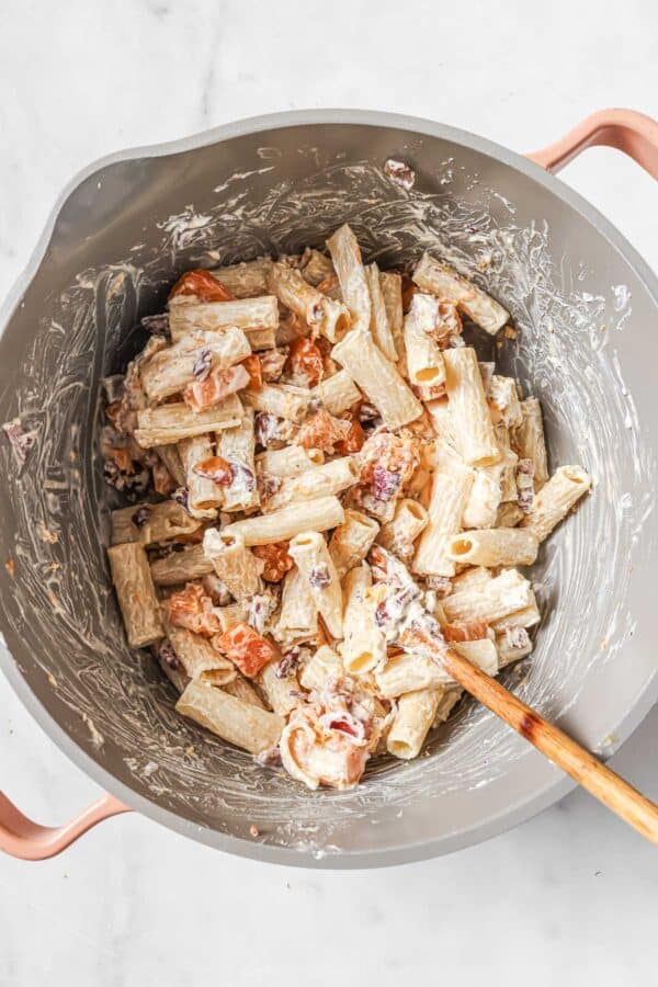 Stirring the pasta together until creamy. 