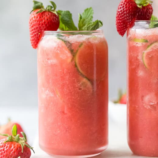 Two glasses of icy strawberry limeade.