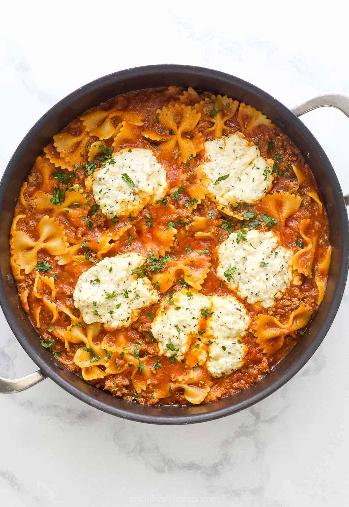 Homemade one-pot beef lasagna with ricotta on top.