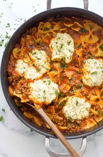 Skillet lasagna with dollops of homemade parmesan-ricotta mixture on top.