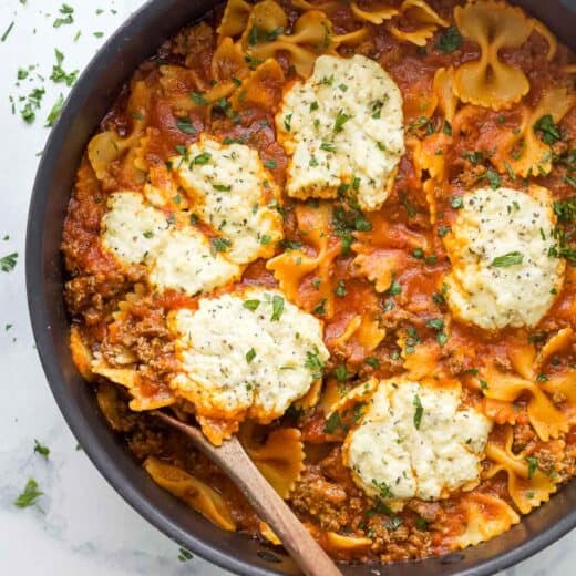 Skillet lasagna with dollops of homemade parmesan-ricotta mixture on top.