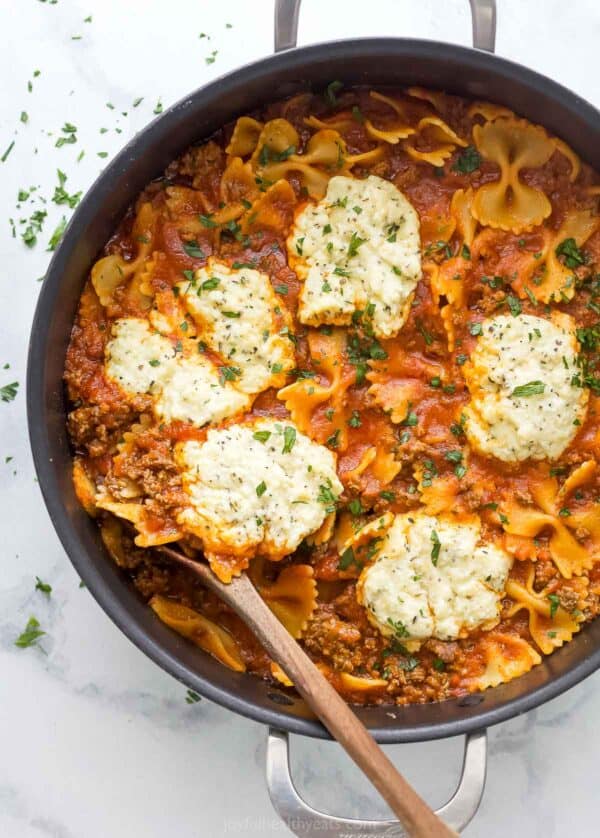 Skillet lasagna with dollops of homemade parmesan-ricotta mixture on top.