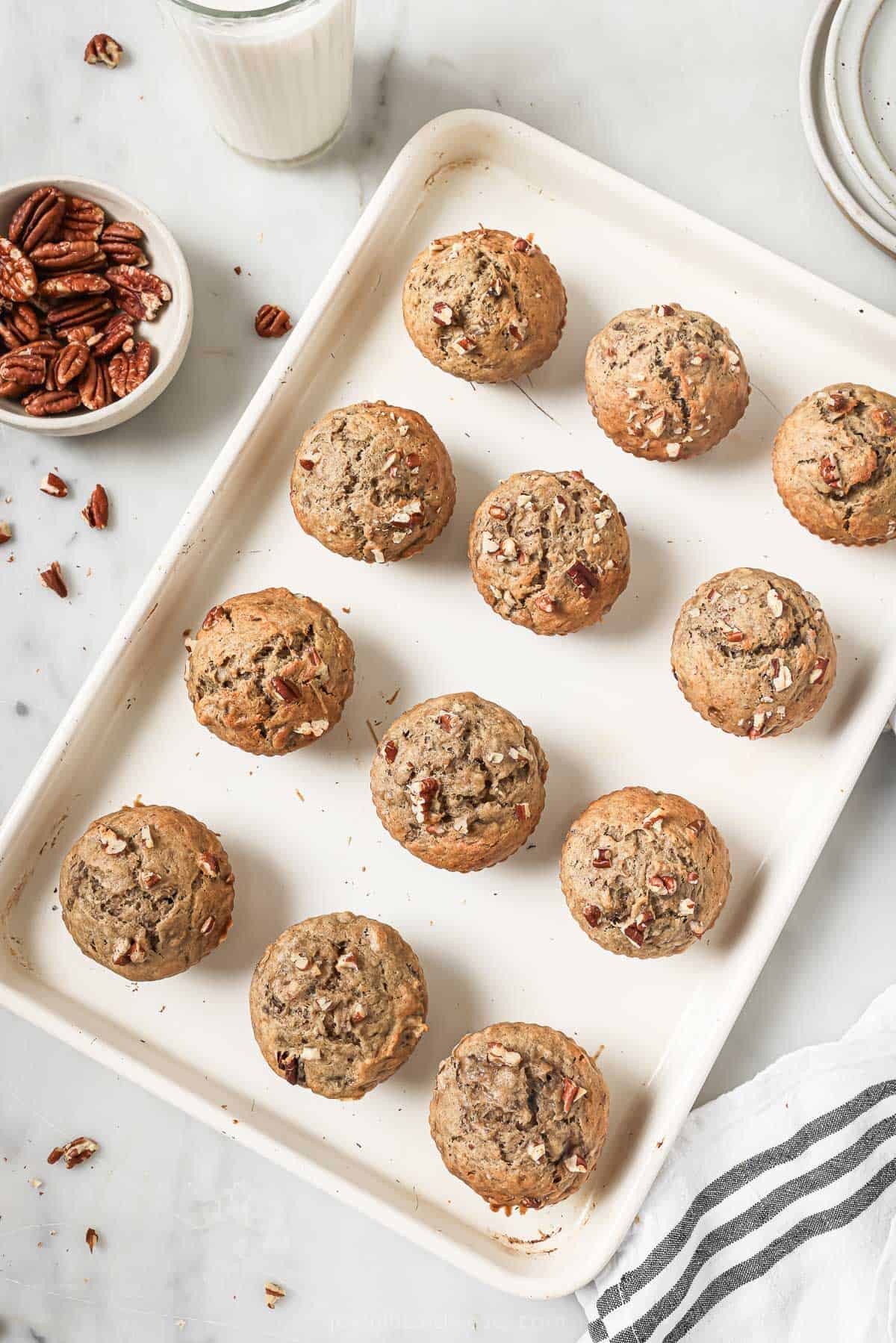 Homemade banana nut muffins on a baking sheet. 