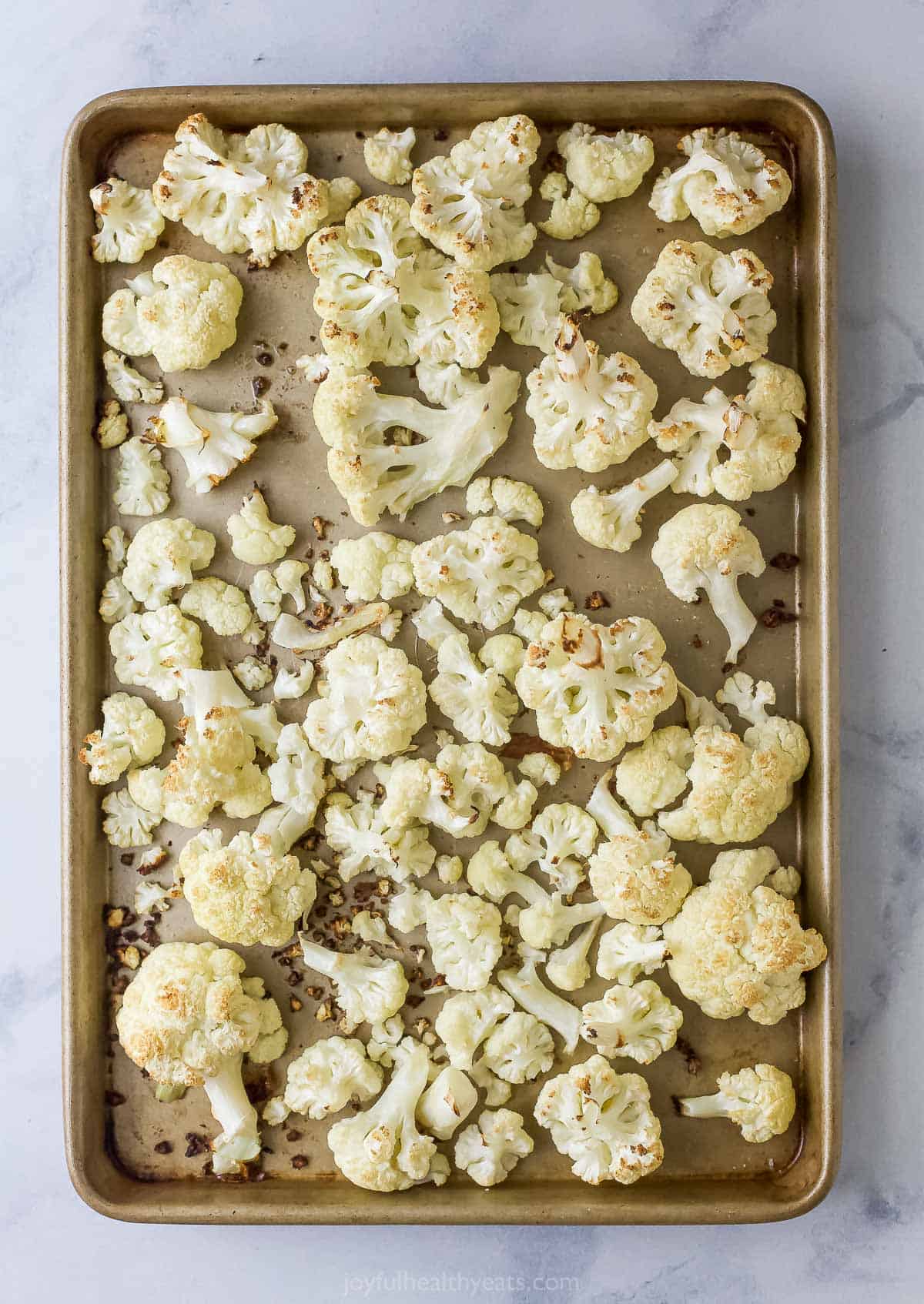 Roasted cauliflower in a baking tray. 